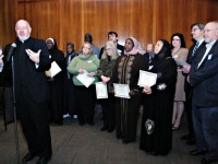 Msgr. Kevin Sullivan, executive director of Catholic Charities for the Archdiocese of New York, addresses the conference, accompanied by Catholics and Muslims who work together in social service projects in the archdiocese. (photo: Bob Gore)
